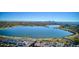 Panoramic aerial view of a lake surrounded by trees and a cityscape in the distance at 4710 W 32Nd Ave, Denver, CO 80212