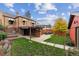 Brick home backyard with green lawn, wood storage, patio set, and surrounding fence at 4710 W 32Nd Ave, Denver, CO 80212