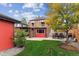 Brick home backyard with green lawn, wood storage, patio set, and surrounding fence at 4710 W 32Nd Ave, Denver, CO 80212