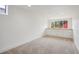 Finished basement area with carpet, built-in cabinets, and a window providing natural light at 4710 W 32Nd Ave, Denver, CO 80212