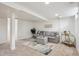 Cozy basement featuring a gray sofa, area rug, and minimalist decor at 4710 W 32Nd Ave, Denver, CO 80212