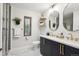 Stylish bathroom featuring a double vanity with gold fixtures and marble floors at 4710 W 32Nd Ave, Denver, CO 80212