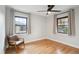 Bright bedroom featuring wood floors, neutral walls, and a leather chair near a window at 4710 W 32Nd Ave, Denver, CO 80212