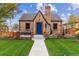 Charming brick home with a well-manicured lawn and a welcoming blue front door at 4710 W 32Nd Ave, Denver, CO 80212
