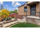Brick home exterior with back patio, lawn, and red shed viewed from the backyard at 4710 W 32Nd Ave, Denver, CO 80212