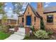 Close up of brick house with front porch and blue door at 4710 W 32Nd Ave, Denver, CO 80212