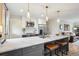 Open concept kitchen with stainless steel appliances, white cabinets and gray lower cabinets with a marble countertop at 4710 W 32Nd Ave, Denver, CO 80212