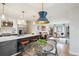 An open concept kitchen with island seating and a dining table that leads to a living room at 4710 W 32Nd Ave, Denver, CO 80212