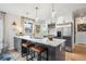 Well-lit kitchen with a large island, marble countertops, and stainless steel appliances at 4710 W 32Nd Ave, Denver, CO 80212