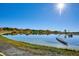 Scenic lake view with calm waters, trees, and a boat on the shoreline at 4710 W 32Nd Ave, Denver, CO 80212