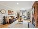 Cozy living room features a fireplace, wood floors, a leather couch, and several chairs at 4710 W 32Nd Ave, Denver, CO 80212