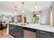 Open concept kitchen featuring an island with marble countertops and a living room with a fireplace at 4710 W 32Nd Ave, Denver, CO 80212