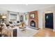 Living room featuring a brick fireplace, wood floors, a leather couch and white chairs at 4710 W 32Nd Ave, Denver, CO 80212