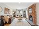 Bright living room featuring a fireplace, wood floors, a leather couch and white chairs at 4710 W 32Nd Ave, Denver, CO 80212