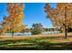 Picturesque park view with a lake, green grass, and trees with colorful autumn foliage at 4710 W 32Nd Ave, Denver, CO 80212