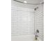 Clean white shower with subway tile and a brushed nickel showerhead at 4710 W 32Nd Ave, Denver, CO 80212