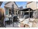 A patio with two dining tables and an outdoor lounge area perfect for entertaining guests in the backyard at 568 Galapago St, Denver, CO 80204