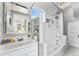 Bright bathroom featuring a combined tub and shower, a mirror, and ample storage at 568 Galapago St, Denver, CO 80204