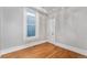 A bright bedroom featuring hardwood floors, fresh paint, and a window that allows natural light to fill the room at 568 Galapago St, Denver, CO 80204