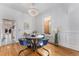 Dining room featuring hardwood floors, a round table with blue chairs, and a chandelier at 568 Galapago St, Denver, CO 80204