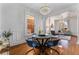 Elegant dining room with hardwood floors, a round table with blue chairs, and a chandelier at 568 Galapago St, Denver, CO 80204