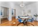 Bright dining room featuring stylish blue chairs, elegant chandelier, and hardwood floors at 568 Galapago St, Denver, CO 80204