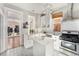 Bright, all-white kitchen featuring subway tile backsplash, stainless steel appliances, and an island at 568 Galapago St, Denver, CO 80204