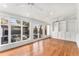 Sunroom with hardwood floors, built-in shelving, and views of the outdoor patio at 568 Galapago St, Denver, CO 80204