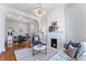 Bright living room features a fireplace, chandelier, and hardwood floors at 568 Galapago St, Denver, CO 80204