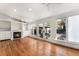 Sunlit living room with hardwood floors, fireplace, and large windows overlooking the outdoor patio at 568 Galapago St, Denver, CO 80204