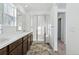Bathroom with double vanity, dark wood cabinets, glass shower, and tiled floor at 23762 E 33Rd Pl, Aurora, CO 80019