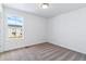 Carpeted bedroom featuring neutral decor, white walls, and a bright window at 23762 E 33Rd Pl, Aurora, CO 80019
