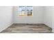 Bright bedroom with natural light showcases neutral walls and wood-style flooring at 23762 E 33Rd Pl, Aurora, CO 80019