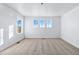 Bright, neutral bedroom featuring three windows allowing natural light to illuminate the carpeted space at 23762 E 33Rd Pl, Aurora, CO 80019