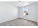 This bedroom features neutral carpet, white walls, and a window overlooking the neighborhood at 23762 E 33Rd Pl, Aurora, CO 80019