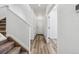 Bright hallway with wood-look flooring, white trim, and door to the exterior at 23762 E 33Rd Pl, Aurora, CO 80019