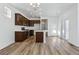 Open-concept kitchen and dining area with wood floors and stainless steel appliances at 23762 E 33Rd Pl, Aurora, CO 80019