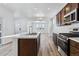 Modern kitchen with stainless steel appliances and a large island, perfect for entertaining at 23762 E 33Rd Pl, Aurora, CO 80019