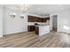 Modern kitchen features a center island with sink, stainless appliances, and wood flooring at 23762 E 33Rd Pl, Aurora, CO 80019