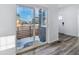 Bright living room showcases sliding glass doors to patio and modern wood-look flooring at 23762 E 33Rd Pl, Aurora, CO 80019