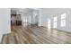 Spacious living room features wood floors, a modern chandelier, and a slider to the backyard at 23762 E 33Rd Pl, Aurora, CO 80019