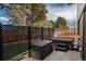 Cozy patio area with a hot tub, privacy screens, and outdoor storage creating a relaxing retreat at 7341 E Jarvis Pl, Denver, CO 80237