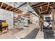 Unfinished basement, ready to customize, includes exercise equipment and work areas at 14805 Quince Way, Thornton, CO 80602