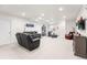 Spacious basement with a media area and a comfortable seating arrangement for entertaining at 14805 Quince Way, Thornton, CO 80602