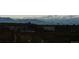 Construction site with snow-capped mountain views, showcasing the development of a new community at 14805 Quince Way, Thornton, CO 80602