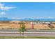 View of construction site with mountain backdrop showcasing new homes in a developing community at 14805 Quince Way, Thornton, CO 80602