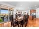 Bright dining area with hardwood floors, a wooden table, chairs, and access to a deck or patio at 14805 Quince Way, Thornton, CO 80602