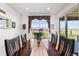 Elegant dining area features a large window and long table, perfect for Gathering meals and entertaining at 14805 Quince Way, Thornton, CO 80602