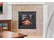 Close up of the fireplace featuring beautiful stone surround and a glass enclosure at 14805 Quince Way, Thornton, CO 80602