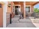 Inviting front porch with decorative wreaths and a seating area, perfect for relaxing outdoors at 14805 Quince Way, Thornton, CO 80602